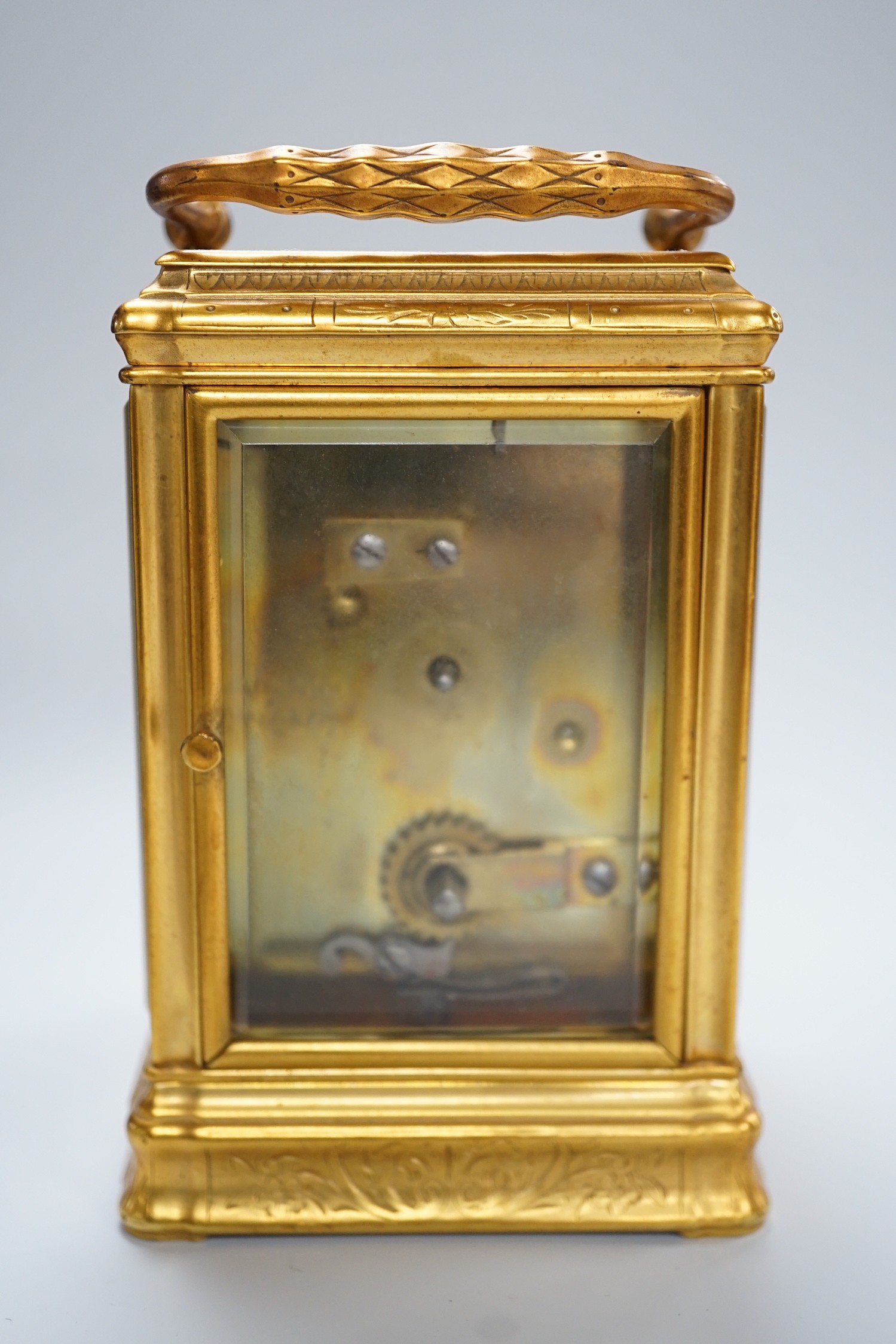 A late 19th century French eight day timepiece, in an engraved brass gorge case. 12cm tall